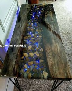 a table that has some rocks on it and water running down the side of it