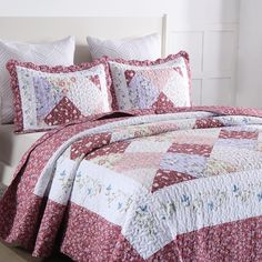 a red and white quilted bedspread on a bed with matching pillow cases