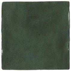 a square green tile with some brown spots on it