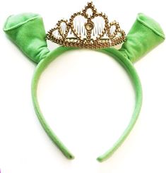 a green headband with a tiara on it's top and two ears