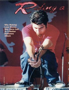 a magazine cover with a man sitting on top of a suitcase and listening to headphones