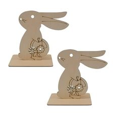 two wooden rabbits with flowers on them