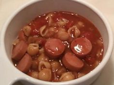 a white bowl filled with beans and sausage