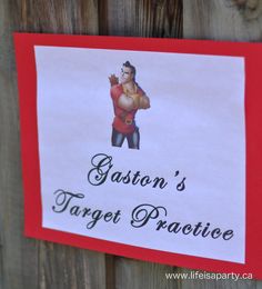 a sign that says, easton's target practice on the side of a wooden fence