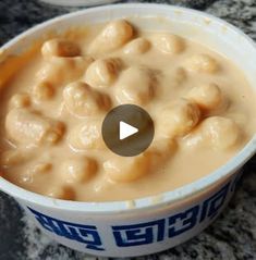 a bowl filled with food sitting on top of a counter next to another bowl full of food