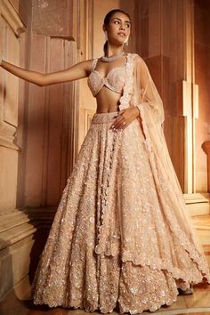 Peach tulle attached cancan lehenga with tonal floral embroidery with sequins, crystals and beadwork. Paired with embroidered padded choli and dupatta. 
Component: 3
Pattern: Embroidered
Type Of Work: Floral
Neckline: Sweetheart
Sleeve Type: Sleeveless
Fabric: Tulle
Color: Peach
Other Details: 
Floral motifs
Embroidered dupatta
Occasion: Bride,Wedding - Aza Fashions Tulle Lehenga, Wedding Lehenga Designs, Desi Wear, Bridal Lehenga Red, Embroidered Lehenga, Desi Girl, Wedding Lehenga, Indian Wedding Outfits, Lehenga Designs