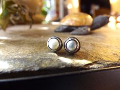 "Sweet creamy pearl buttons are basically set in handcrafted sterling silver bezels in a stud or post setting. The freshwater pearls measure about 6mm. In the earring setting they measure 7mm wide. I have created this setting to appear \"weathered\" and rustic like in appearance. But I can make these with a shiny silver finish as well. Just pick your option. They are great for weddings or even just casual everyday wear! Materials: fresh water creamy pearl, sterling silver recycled Please visit m Silver Jewelry With Pearl Buttons As Gift, Wedding Bridal Jewellery, Oxidized Sterling Silver, Pearl Buttons, Shiny Silver, Sterling Silver Studs, Silver Wedding, Casual Everyday, Silver Studs