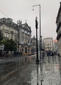 an empty city street is shown in the rain