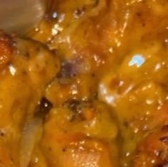 closeup of chicken covered in cheese and sauce