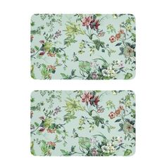 two placemats with flowers on them, one in blue and the other in green