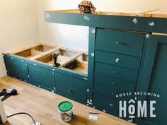 an unfinished room with green cabinets and tools on the floor in front of it that is being built