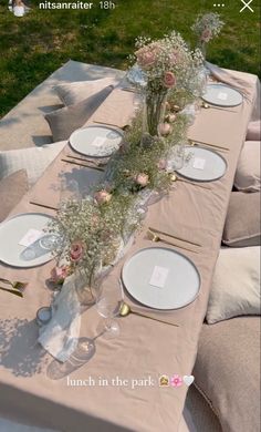 the table is set with flowers and plates