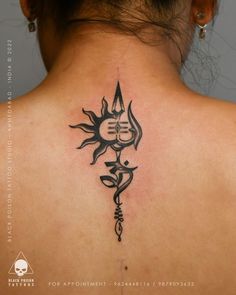 the back of a woman's neck with a tattoo design on it