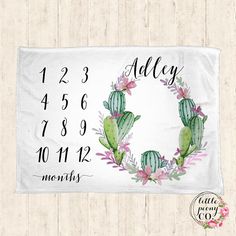 a white towel with a cactus wreath on it and the date printed in black ink