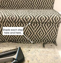 a black and white couch sitting on top of a floor next to a hair dryer