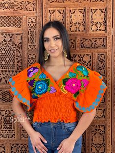 Orange V-neck Top For Festivals, Orange Embroidered V-neck Top, Embroidered Orange V-neck Tops, Orange Short Sleeve Tops With Floral Embroidery, Orange Floral Embroidered Short Sleeve Tops, Orange Floral Embroidery Short Sleeve Tops, Orange Embroidered Tops For Summer, Multicolor V-neck Top For Festivals, Fitted Embroidered Orange Tops