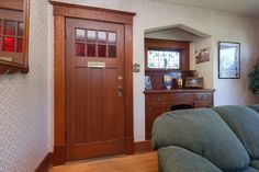 a living room filled with furniture and a wooden door