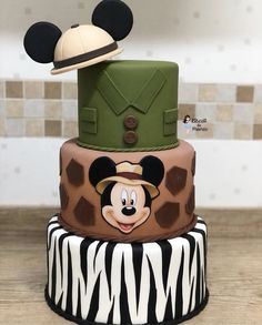 three tiered cake decorated with mickey mouse and zebra print, including an army hat