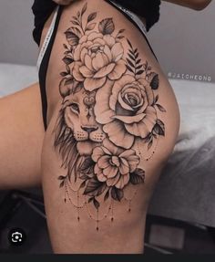 a woman's thigh with flowers on it and a deer head in the middle