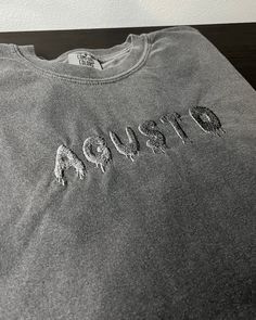 PLEASE READ *All orders placed after Dec. 3 are not guaranteed to be shipped out in time for Christmas.  AGUST D Embroidered Shirt SHIRT SIZE Size chart available in photos CARE INSTRUCTIONS Wash in delicate cold cycle. Air dry to ensure to longevity of the shirt. PROCESSING TIME  These are made to order shirts/sweatshirts. Current processing time is 2-4 weeks.  RETURN/EXCHANGE POLICY This is a made to order item, therefore Returns or Exchanges are not accepted. Before placing your order, please Cotton T-shirt With Custom Embroidery For Streetwear, Casual Short Sleeve Sweatshirt With Custom Embroidery, Custom Embroidery T-shirt With Relaxed Fit For Streetwear, Custom Embroidery Relaxed Fit T-shirt For Streetwear, Relaxed Fit T-shirt With Custom Embroidery For Streetwear, Custom Embroidered Relaxed Fit T-shirt For Streetwear, Custom Embroidery Short Sleeve T-shirt For Streetwear, Custom Embroidered Short Sleeve T-shirt For Streetwear, Black T-shirt With Custom Embroidery For Streetwear