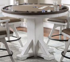 a round table with four stools around it