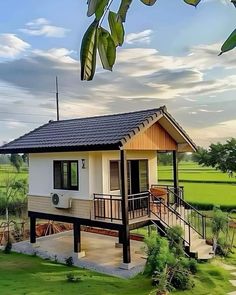 a small house with a porch and stairs