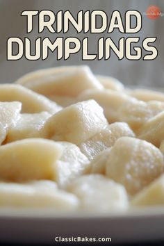 a white plate topped with dumplings on top of a table