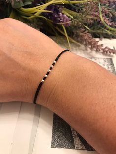 Elevate your accessory game with our Black Cord Karma Bracelet, a versatile piece designed to bring luck and positive energy to the wearer. When you wear a black cord bracelet on the wrist of your right or left hand, you can create your own, very strong amulet, which is of particular importance for its owner. He will always come to you with help in difficult situations and will protect you from many of life's troubles and ailments. This bracelet is perfect as a thoughtful gift for your dad or br Minimalist Black Bracelet, Black Thread Bracelet, Black String Bracelet, Boho Minimalism, Dad Bracelet, Kabbalah Bracelet, Karma Bracelet, Wax Cord Bracelet, Thread Bracelet