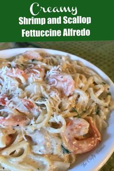 shrimp and scallop fettuccine alfredo on a white plate with text overlay