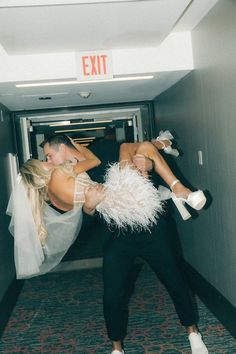 a man and woman are dancing in an exit way with their arms around each other