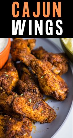 chicken wings on a plate with dipping sauce