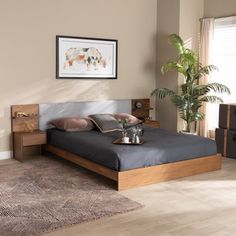 a bed room with a neatly made bed next to a window and a potted plant