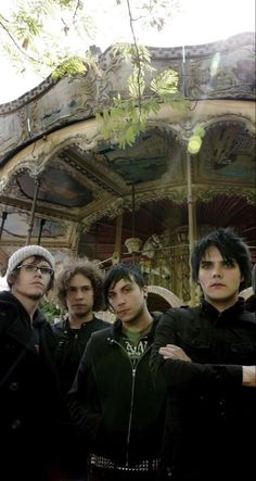 five young men standing in front of a carousel