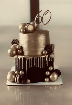 a three tiered cake with gold and silver decorations