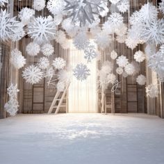 an open stage with snowflakes hanging from the ceiling and ladders in front of it