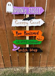 a wooden sign that says spooky street, creepy court, boo boulevard and haunted highway