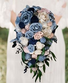 a bridal holding a bouquet of blue and pink flowers