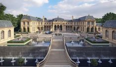 a large building with many fountains in the front and stairs leading up to it's entrance