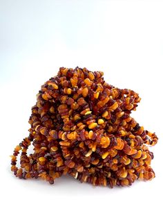 a pile of corn sitting on top of a white table next to a red and yellow object