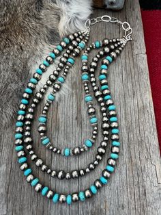 Save 5% on every item by shopping on our website navajopearlsranch.com 3 Strand Showstopper!   Navajo Pearls & Turquoise 3 strand necklace ~ Choose Length Handmade by Navajo Artists exclusively for NPR and Western Pearls. A gorgeous triple strand of Navajo pearls & turquoise. Made with beads of a German silver and white bronze alloy. Our Navajo artists antique & hand polish them creating a perfect Navajo pearl! They have the same lifelong quality and all of the look and weight of solid sterling Navajo pearls! Designs by Jona Bonecutter ~ Handmade by Navajo Artists ~ Marlene Gorman ~ Alaina Beautiful Bald Eagle~ Kayla John~ Brendan Allen   Hand antiqued & polished creating shimmering, perfect, Navajo pearls Accented with sky blue turquoise and silver "saucer" beads You won't find a better p Navajo Pearl Jewelry, Navajo Pearls, Navajo Style, Turquoise Jewelry Native American, Long Pearl Necklaces, American Indian Jewelry, Silver Bead Necklace, Southwestern Jewelry, Western Jewelry