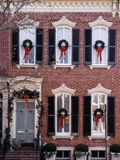 a brick building with wreaths on the windows