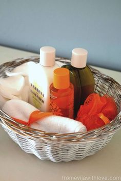 a basket filled with bottles and soaps sitting on top of a white countertop