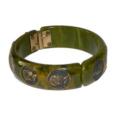 "Item: This is a spinach green bakelite clamper bangle with some nice marbling and little coins inset encircling the bracelet. The hinge works fine and I don't see any major scratching or chips. Tested and guaranteed vintage bakelite. Be sure to check our other listings for lots more bakelite jewelry! Measurements: 3/4\" wide - 2 1/2\" inner diameter, about 7 3/8\" inner circumference. Condition: 9 - Very good, slightly misaligned, otherwise in excellent condition. Shipping: Shipping in the U.S. Bakelite Jewelry, Heart Button, Vintage Bakelite, Red Rhinestone, Rhinestone Bracelet, Photo Bracelet, Antique Items, Bangle Bracelets, Vintage Jewelry