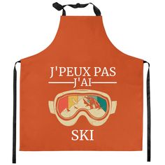 an orange apron that says j'peux pas ja ski with goggles on it