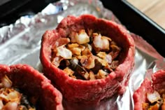 some food is sitting on top of tin foil and ready to be cooked in the oven