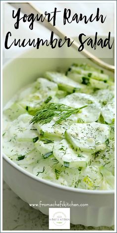 a white bowl filled with cucumber salad on top of a table