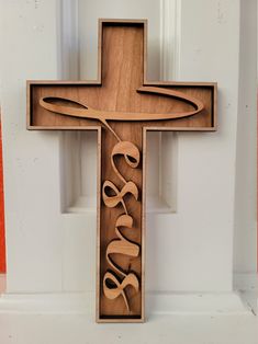 a wooden cross with the word jesus on it