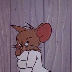 a cartoon character with an evil look on his face and ears, leaning against a wooden wall