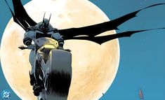 a batman riding on the back of a motorcycle in front of a moon filled sky