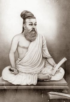 an old photo of a man with a beard sitting in front of a book and holding a pen